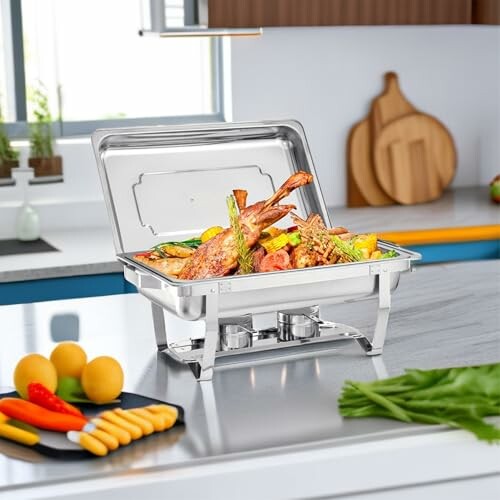 Chafing dish with assorted food on a kitchen counter.