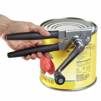 Hand using a can opener on a tin can.