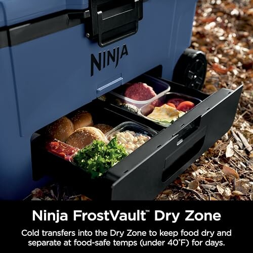 Ninja FrostVault cooler with open dry zone drawer containing various food items.