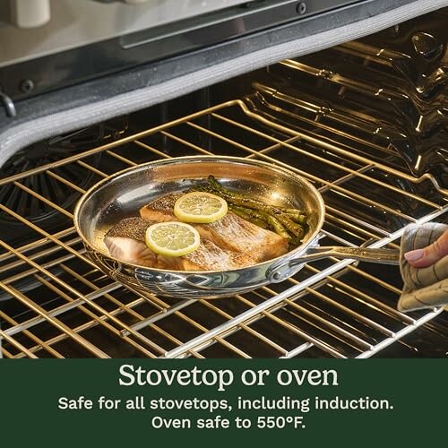 Oven with pan containing salmon, lemon slices, and asparagus.
