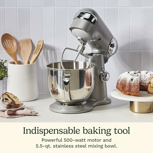Stand mixer with stainless steel bowl, wooden utensils, and baked goods.
