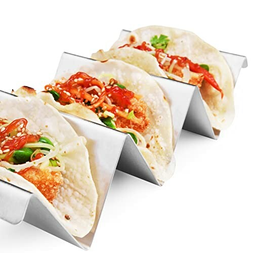 Tacos in a metal holder with various toppings.